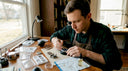 Watchmaker assembling Seiko mod at workbench